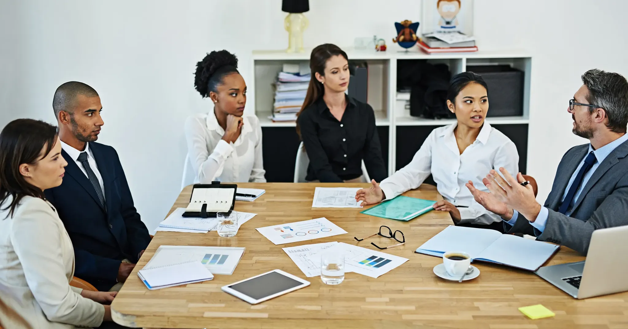 Business team discussing website service structure and planning around a meeting table